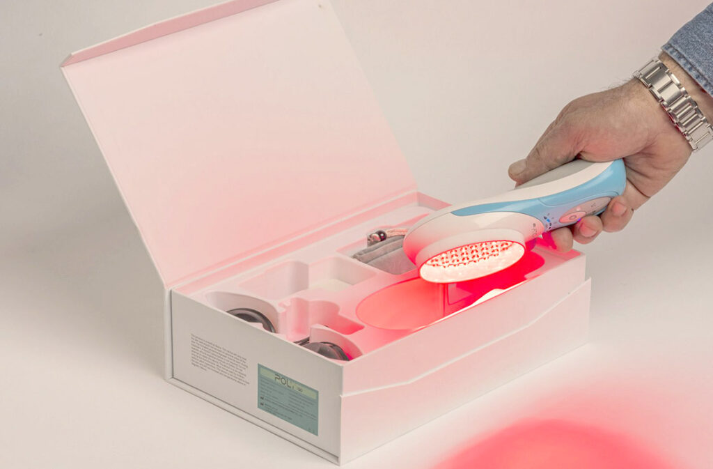 Unboxing a POLY LED Red Light therapy handheld device for light therapy treatment.